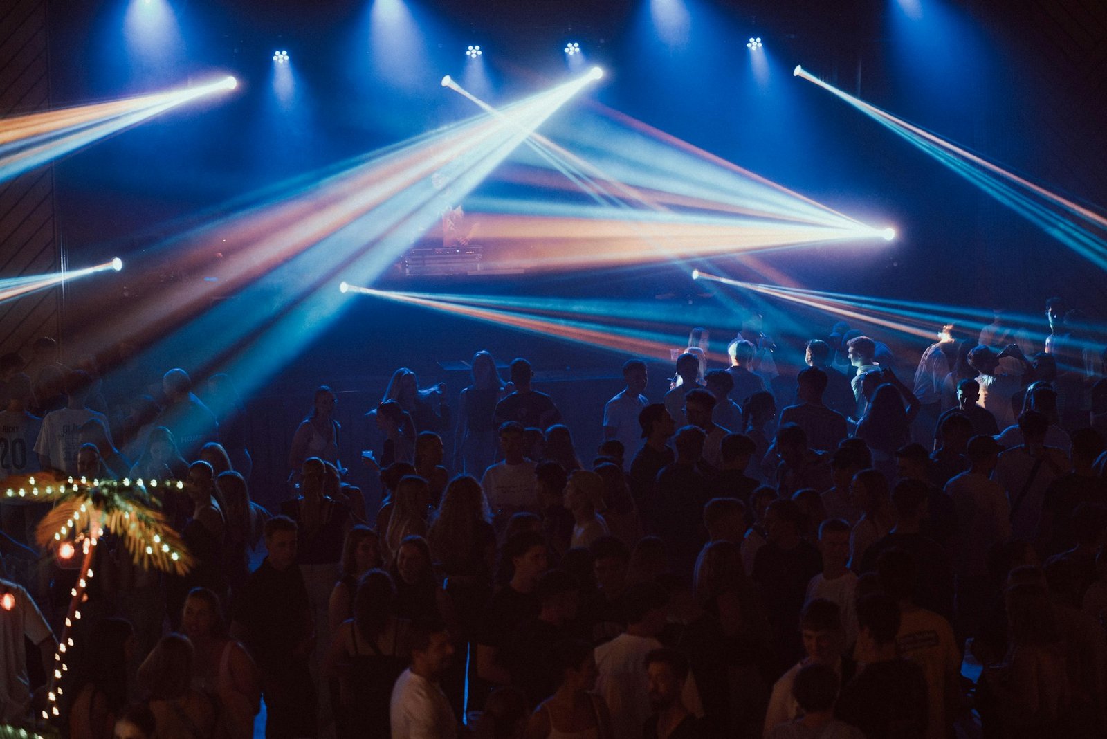 Crowd dancing under colorful lights